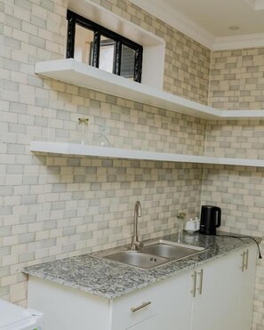 Basic Room, 1 Bedroom, Balcony, Garden View | Private kitchen | Fridge, cleaning supplies, paper towels - Igitego Hotels (Kigali)