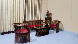 A living room with a sofa, armchairs, and a coffee table. - Hotel O Near Tugu Yogyakarta 2 formerly Monjali Inn (Sinduadi)