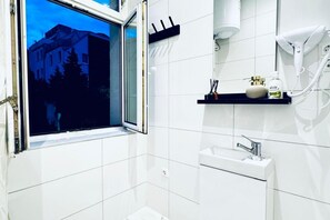 Shower, hair dryer, towels, soap