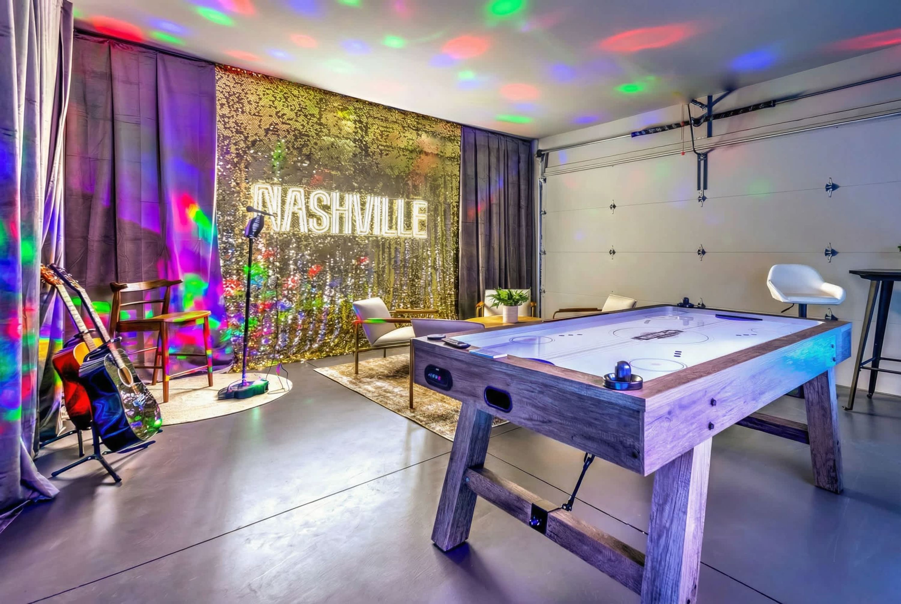 A pool table, a guitar, a chair, a neon sign, and a wall with a decorative pattern.