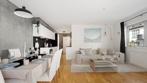 Un espacio de estar moderno con comedor, sofá y mesa de centro.