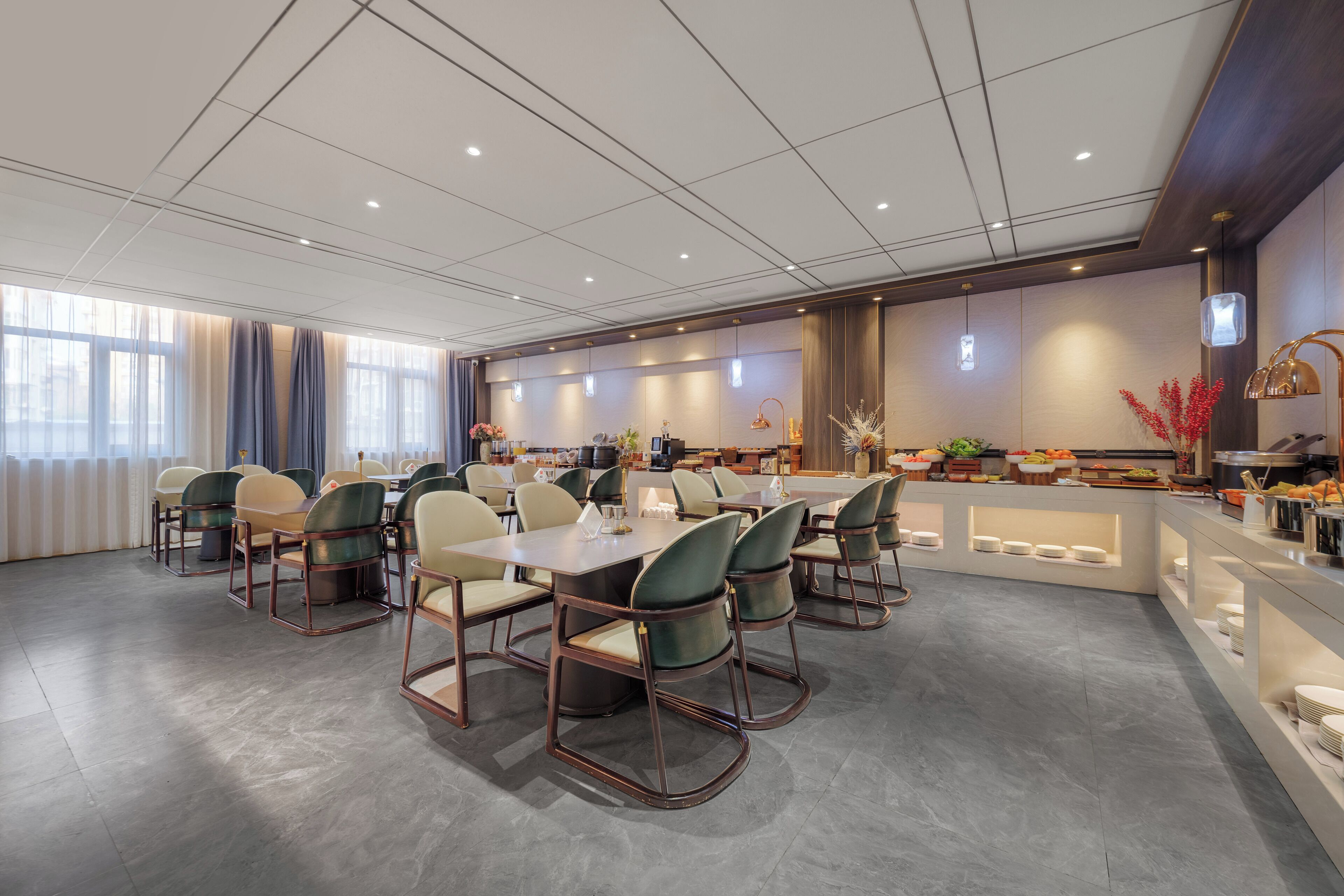 A modern dining area with a long table, chairs, and a buffet counter.