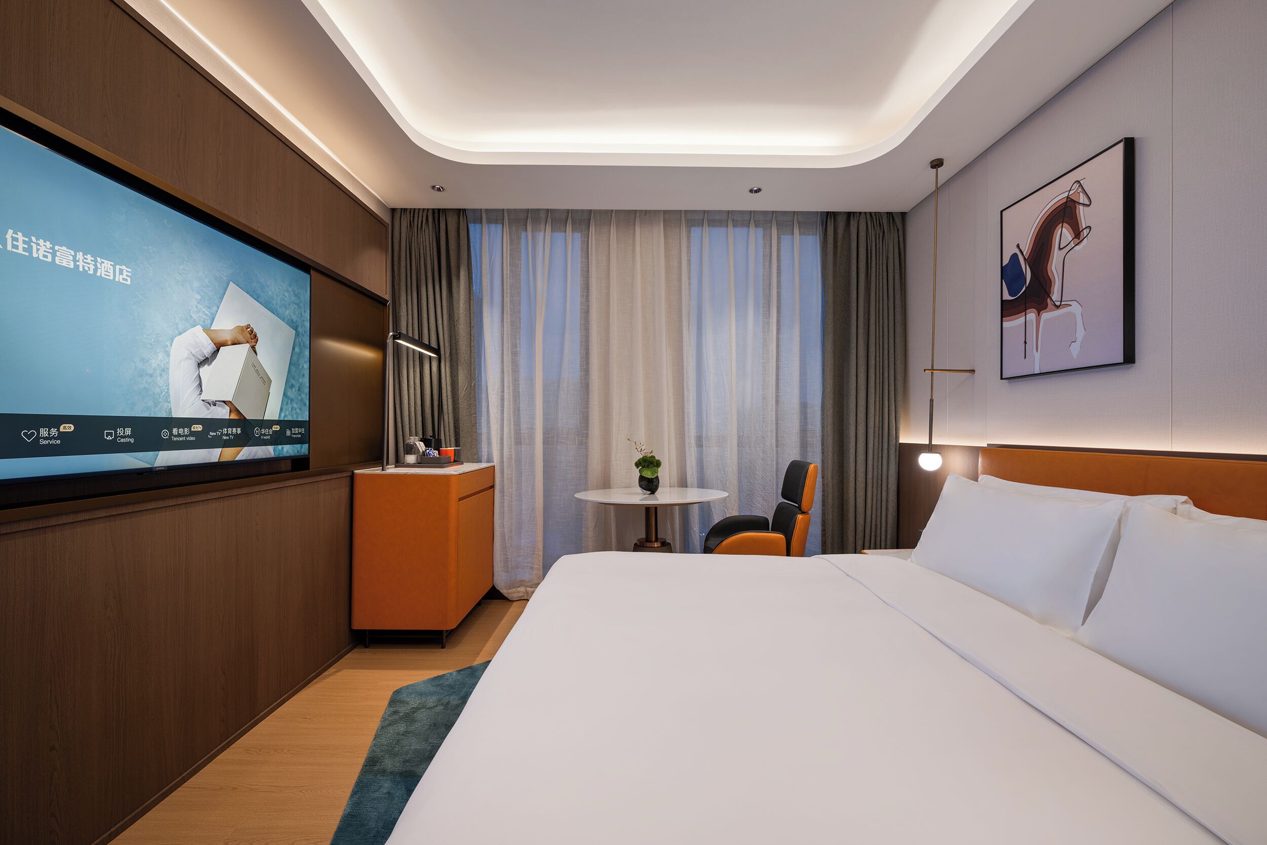 A modern hotel room with a large bed, a desk, a television, and a painting on the wall.
