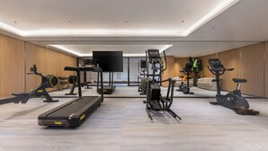 A modern gym with various exercise equipment including treadmills, elliptical machines, and weight machines. - Novotel Shanghai Hongqiao International Airport (Shanghai)
