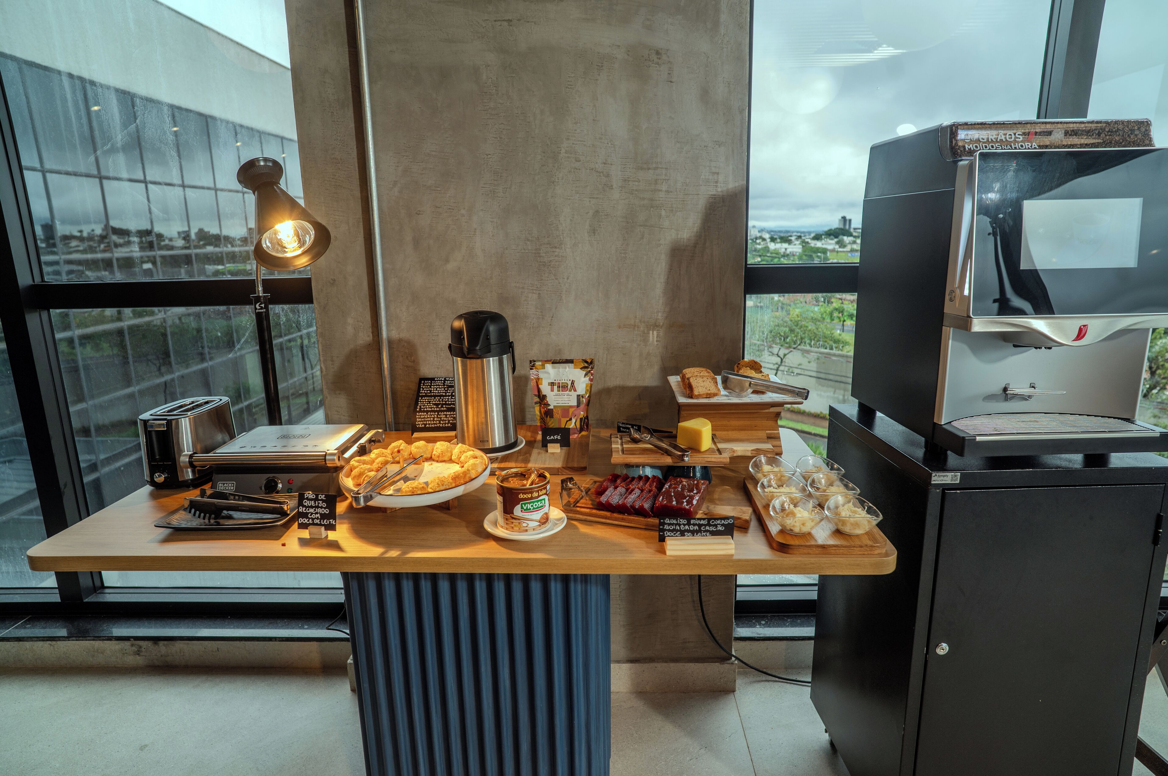 A breakfast bar with a toaster, coffee maker, and various food items.