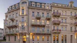 A multi-story building with ornate architectural details, including balconies with decorative railings and a prominent entrance. - Swissôtel Marianske Lazne - Opened in December 2025 (Marianske Lazne)