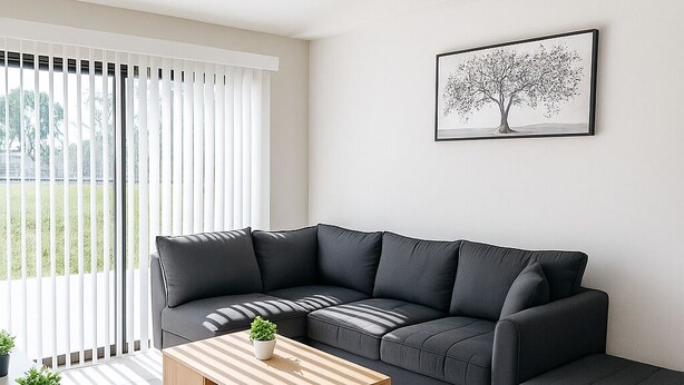 A modern living room with a sectional sofa, a wooden coffee table, and a grey rug. - Spacious 3-Bedroom Getaway — Perfect for Families or Groups!” (Cape Coral)
