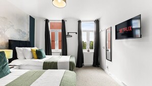A hotel room with two beds, a TV, and a view of the outside. - Boutique Bristol Abode - Games Room (Bristol)