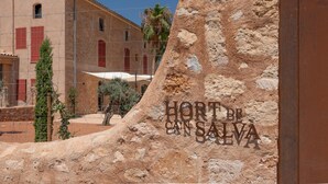 A building with a sign reading 'HORT DE SAN SALVA' and a sandy area in front. - S' Hort de ca'n salvà (Santa Maria del Camí)