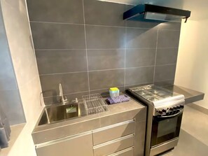 Deluxe Room, City View | Private kitchen | Fridge, microwave, oven, stovetop