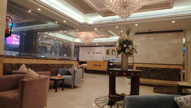 A hotel lobby with plush seating, a reception desk, and a chandelier. - ALMOHAJER SERVICED APARTMENTS (Jeddah)
