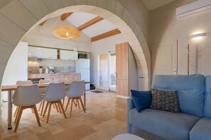 A modern interior with a dining area, kitchen, and living space. - 'Le Ventoux', Wi-Fi and Air Conditioning (Tulette)