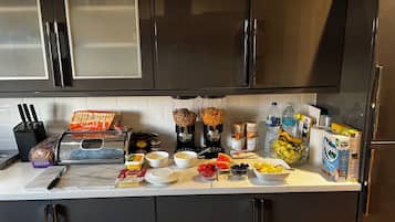 A kitchen counter with various food items, a toaster, and a blender.
