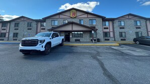 A multi-story building with a brick facade and a sign that reads "Super 8". - STAY MORE, SPEND LESS (Kutztown)