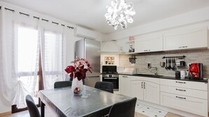 A modern kitchen with white cabinets, a stainless steel refrigerator, a gas stove, and a coffee machine. - Casa Luna with Private Terrace, Wi-Fi and Air Conditioning (Balestrate)