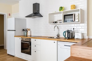 Eine kleine Küche mit Mikrowelle, Toaster, Spüle und Geschirrspüler.
