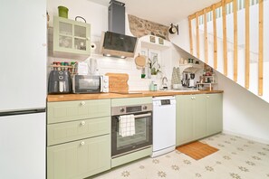 A kitchen with a microwave, toaster, oven, and dishwasher.