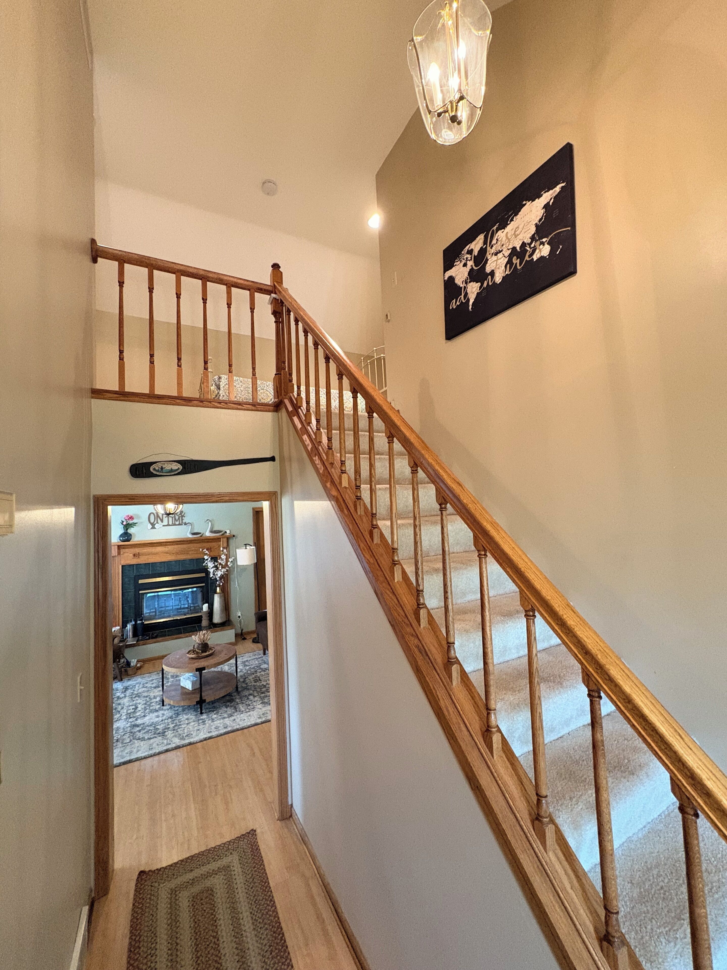 A staircase with wooden railings leading to a second floor.