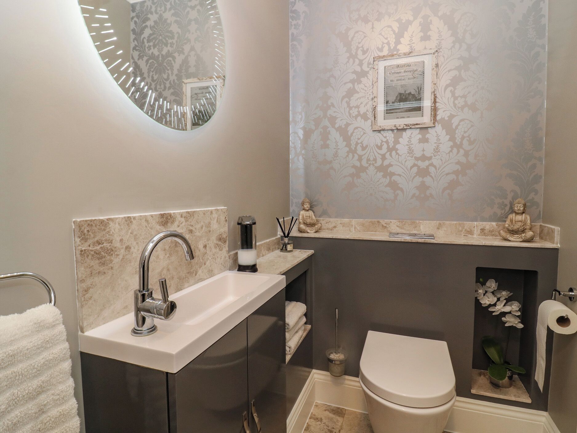 A modern bathroom with a vanity, sink, and toilet.