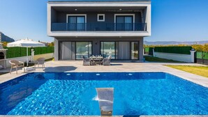 A modern two-story house with a swimming pool in the foreground. - Villa Grand Yasar 4 With 4 Bedrooms and 4 Bathrooms (Ortaca)