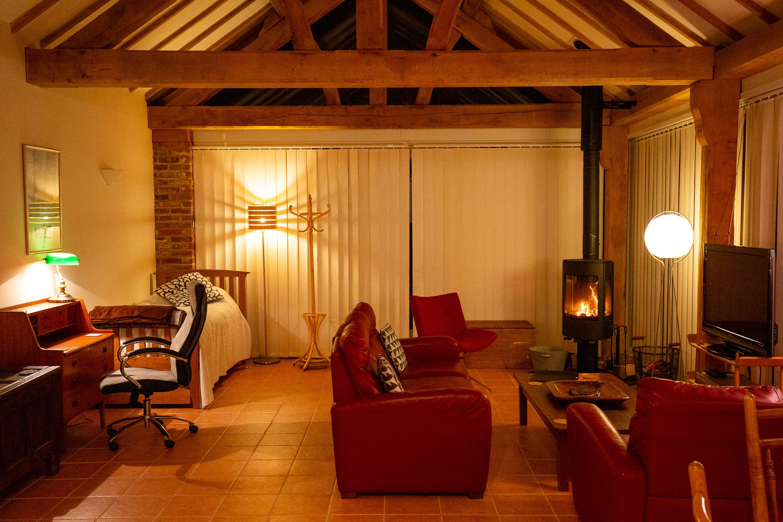 A cozy living room with a fireplace, comfortable seating, and a television.