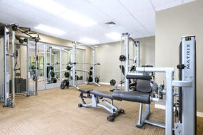 A gym with various exercise equipment, including a bench press, weight machines, and free weights. - Honua Kai | Ocean View 7 BR, Sleeps 20 | Car Incl. w/ 6+ Nights | HKH ML-1949 by KBM (Lahaina)