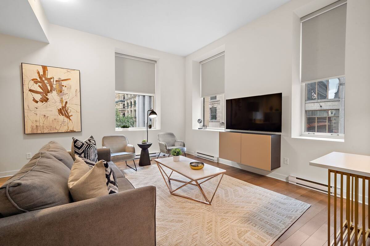 A modern living room with a sofa, coffee table, and TV.