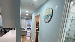 A modern kitchen with a white countertop and wooden cabinets. - Back Bay Getaway (Wildwood)