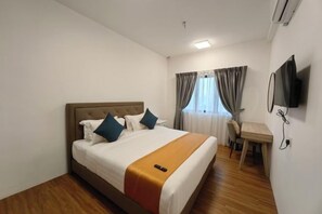 A hotel room with a bed, a desk, a chair, a television, and a window with curtains. - UCSI Residence 2 By UCSI Hotels (Kuala Lumpur)