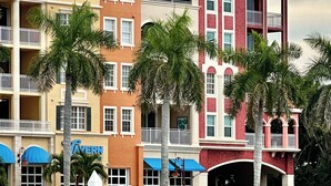 A marina with boats docked, a waterfront restaurant, and multi-story buildings with balconies. - Luxury 2 Bed 2 Bath  Penthouse Bayfront Condo off 5th Avenue (Naples)