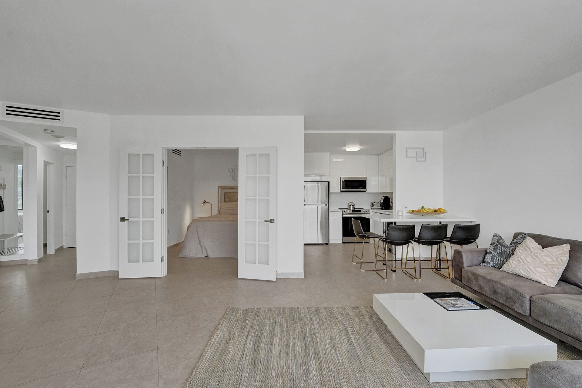 A modern apartment with a living room, kitchen, and dining area.