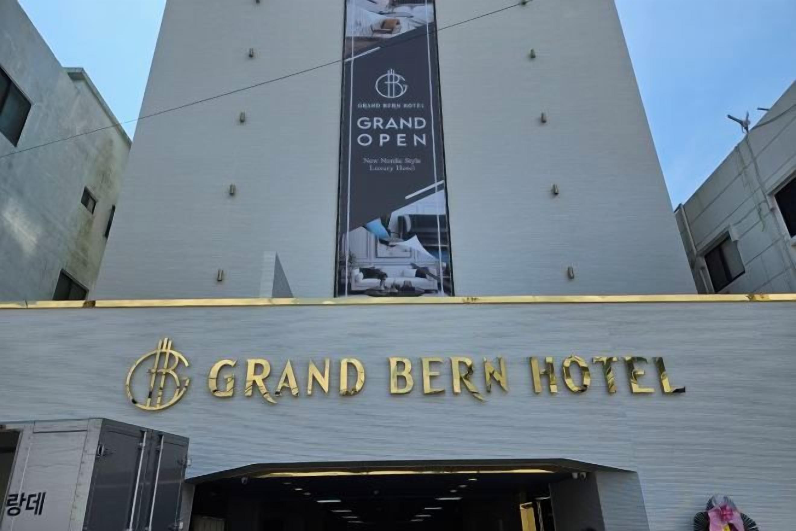 The Grand Bern Hotel with a prominent sign and a banner advertising the Grand Open.