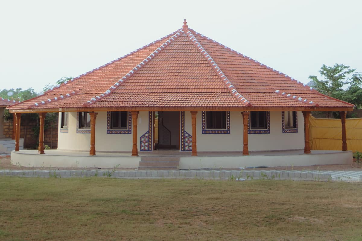 A single-story building with a tiled roof and a covered porch.