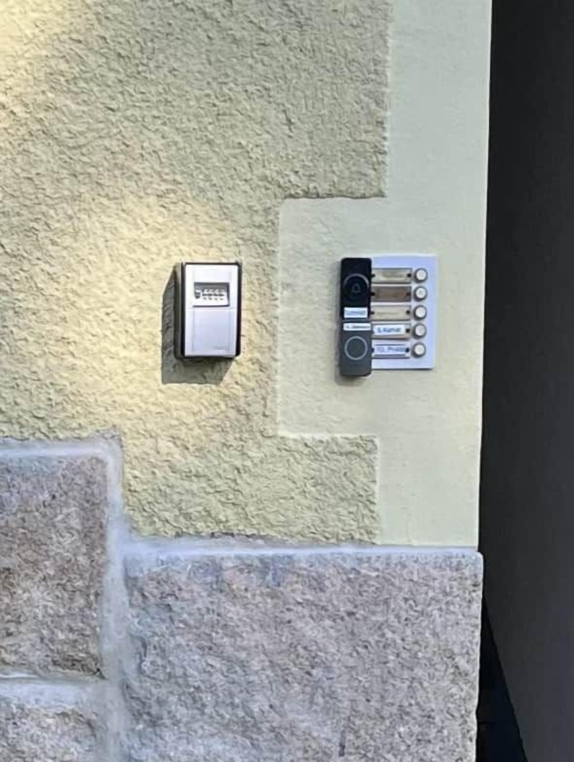 A wall-mounted intercom and a panel with buttons, likely for room access or communication.