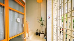 A hotel entrance with a closed sign, potted plants, and a view of the street through a glass door. - Swing & Pillows @ Armenian Victoria , Georgetown Penang (George Town)