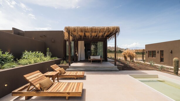 A rooftop lounge with wooden loungers, a thatched-roof structure, and a pool. - Macal Cachi Luxury Lodge (Cachi)