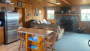 A cozy cabin interior with a kitchen, dining area, and living room. - 3 Bedroom Lakefront home on Maidstone Lake (Maidstone)