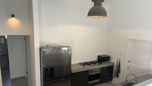A modern kitchen with stainless steel appliances, a gas stove, and a microwave.