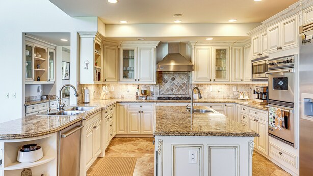A spacious kitchen with white cabinetry, granite countertops, stainless steel appliances, and a central island. - Outdoor Oasis! Luxe Hilltop Home in San Marcos (San Marcos)