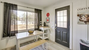 A kitchen with a window, a sink, a coffee machine, and a door with a sign. - Time Machine: Games Galore in Lubbock Home By TTU! (Lubbock)
