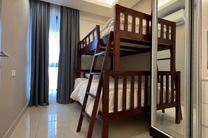 A room with bunk beds, a ladder, a window with curtains, and a door. - Cozy Breezing Retreat at I.D. Genting Highlands, Lvl 23 (Genting Highlands)
