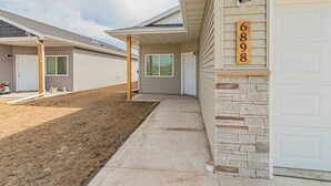 A row of single-story houses with attached garages, numbered 6898. - Cozy 3bd/2ba House in Horace (Horace)