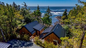 A coastal cabin with a view of the ocean, surrounded by dense forest. - Fogged Inn (Ucluelet)