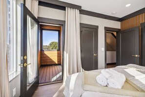 A bedroom with a bed, a window, and a door leading to a balcony. - East Nash Luxury Escape w/Rooftop Deck-Sleeps 12! (Nashville)