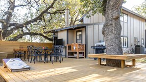 A wooden deck with outdoor furniture, a grill, and a large tree. - 4 mi to Aggieland, Yard & Deck (Bryan)