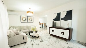 A modern living room with a sofa, coffee table, and a large cabinet.