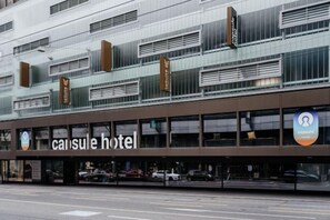 A modern hotel building with a prominent signage for 'capsule hotel.' - Capsule Hotel - Lucerne Old Town (Lucerne)