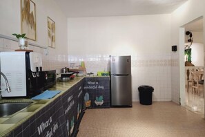 A kitchen with a refrigerator, sink, and a coffee machine. - Damansara Jaya Petaling Jaya 2 Storey Landed House for 15 Pax (Petaling Jaya)
