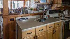 A kitchen with wooden cabinets, a central island, and a microwave.