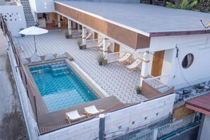 A two-story building with a swimming pool, outdoor seating, and a covered patio area. - Le Soleil Koh Larn (Koh Larn)